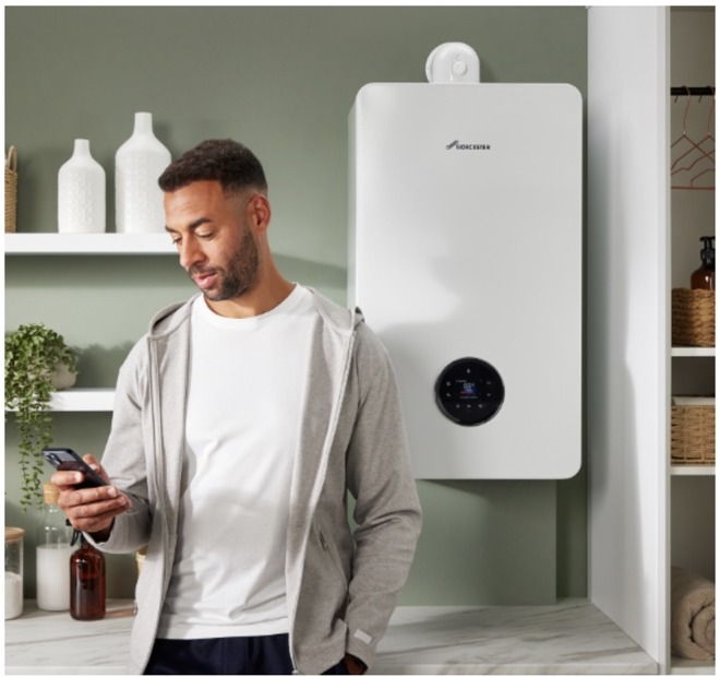 Homeowner using a phone beside a Worcester Bosch boiler